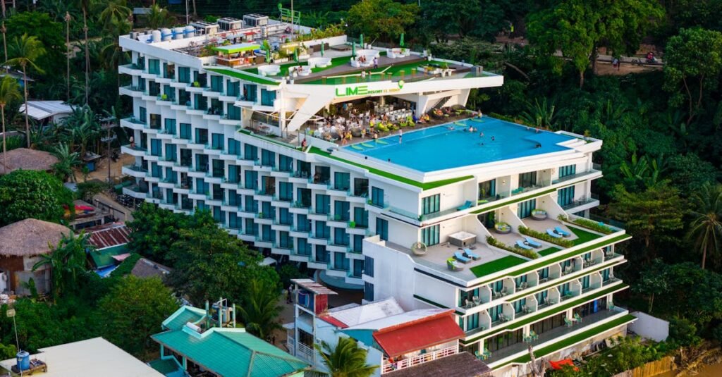 Luxurious rooftop pool at a modern hotel in El Nido, surrounded by lush greenery.