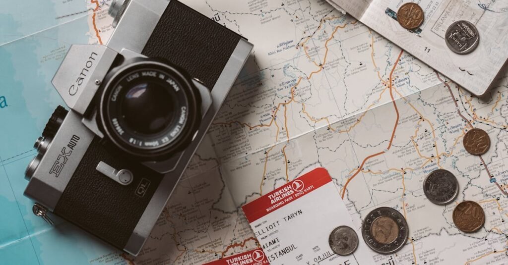 Flat lay travel essentials including passports, tickets, and a vintage camera on a world map.